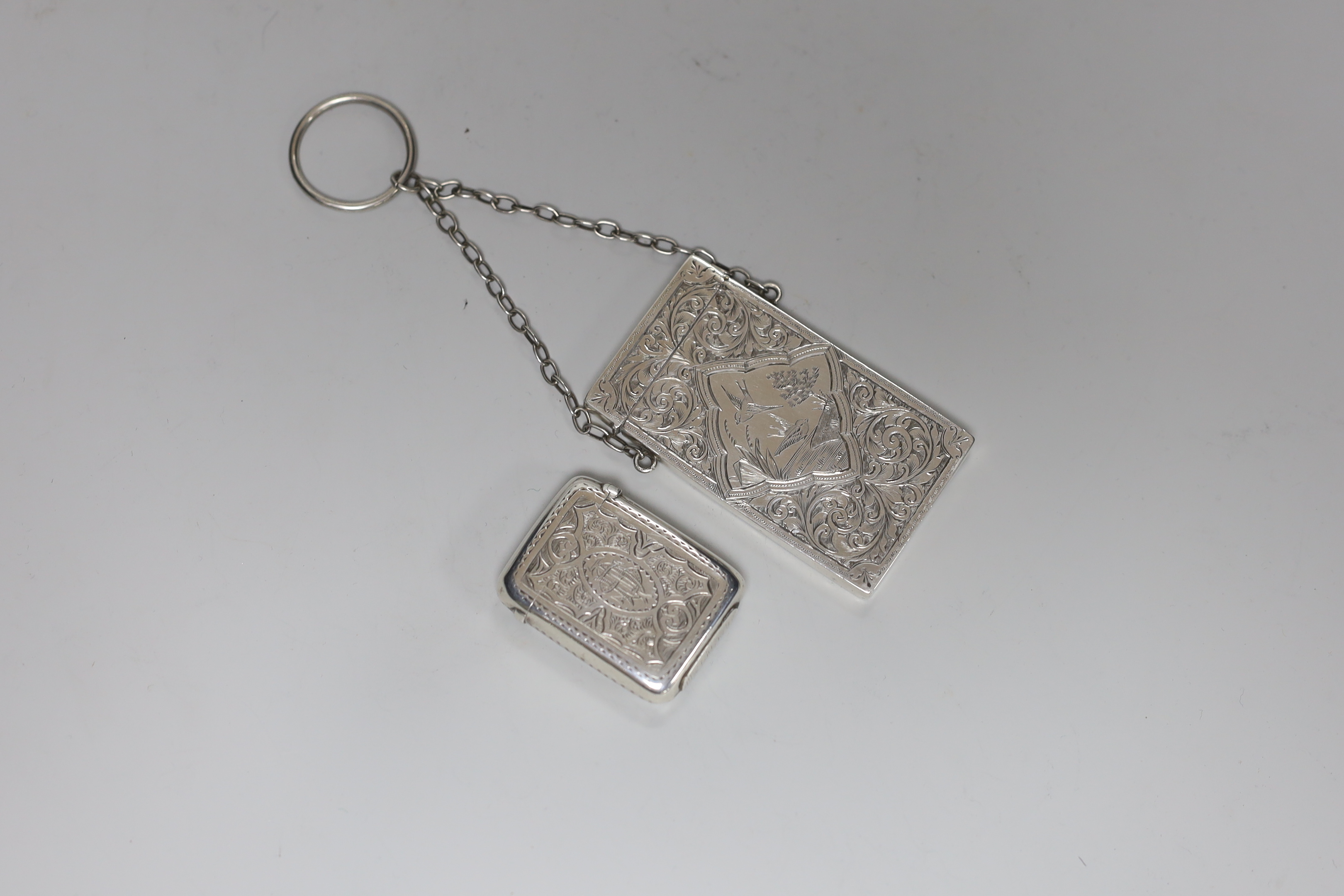 A late Victorian chased silver card case, S. Blanckensee & Son Ltd, Birmingham, 1886, 76mm and a Victorian silver vesta case.